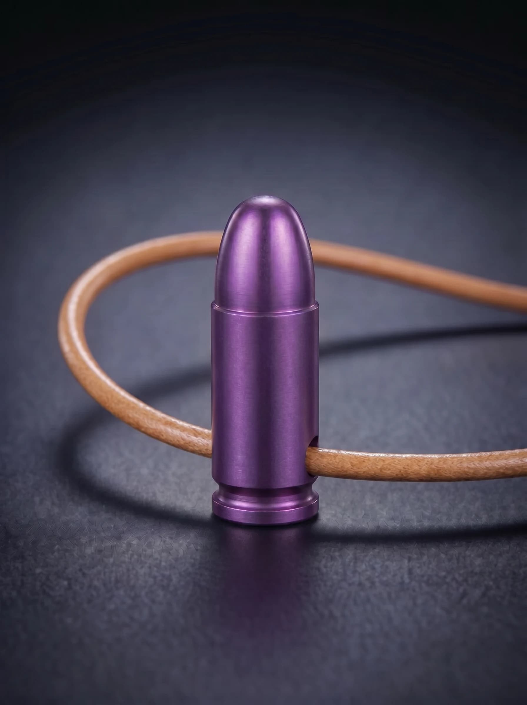 Pistol Cartridge in magenta on original leather cord, view 1