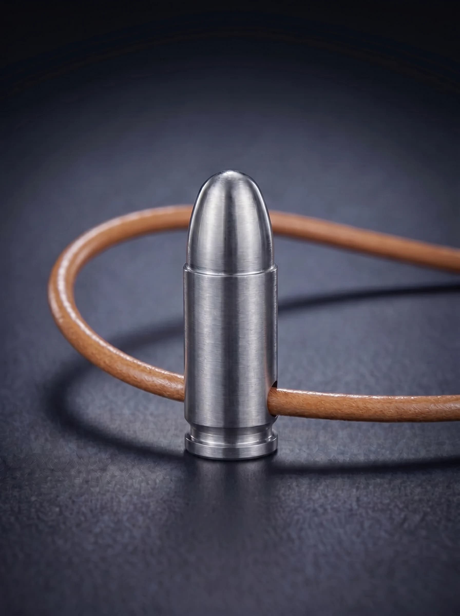 Pistol Cartridge in natural titanium on original leather cord, view 1