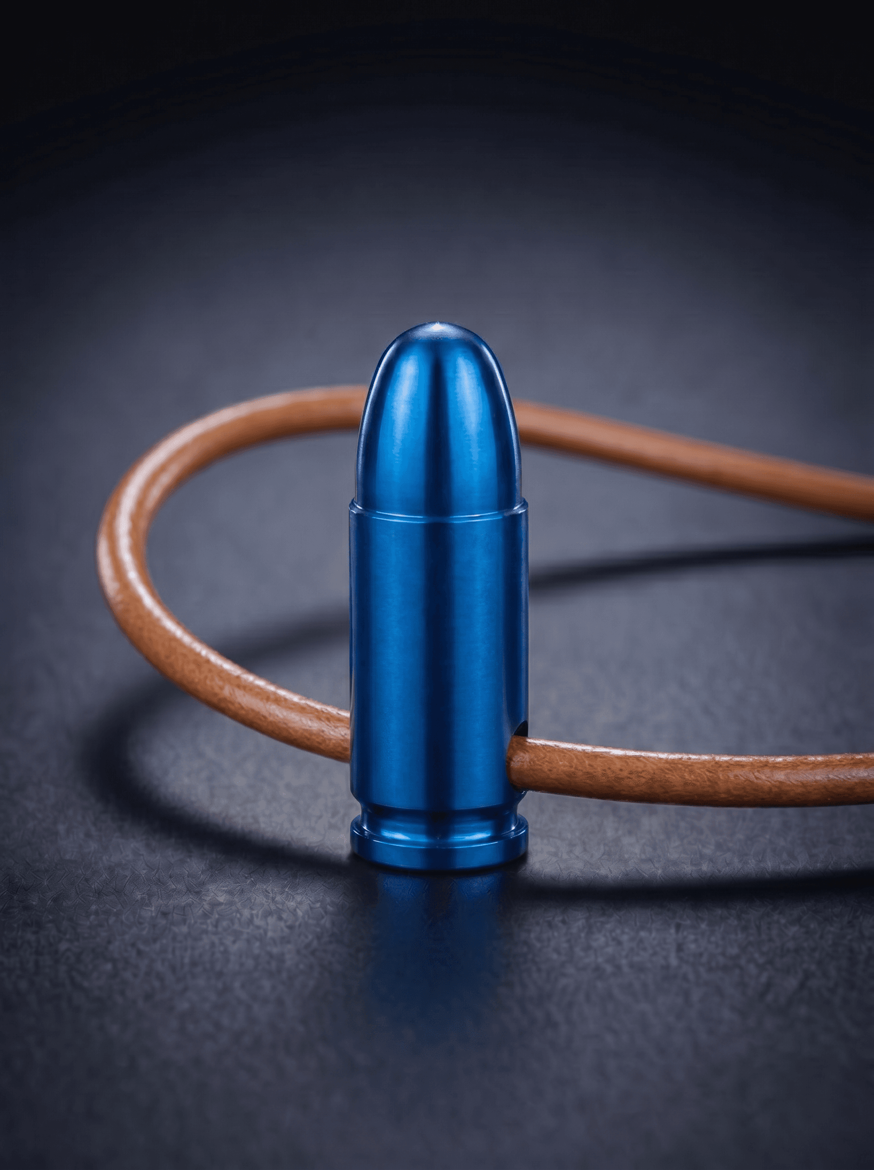 Pistol Cartridge in blue on original leather cord — view 1 — Wear Metal