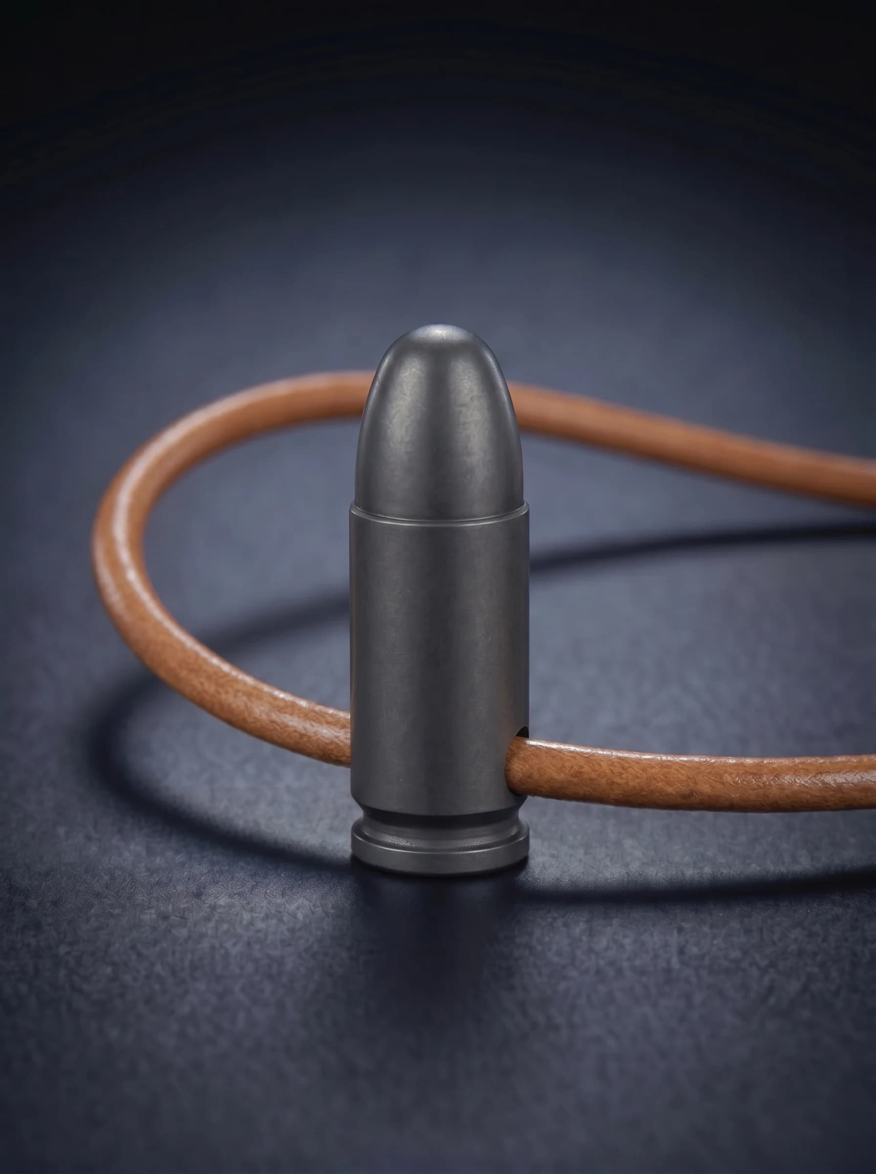 Pistol Cartridge in black on original leather cord, view 1