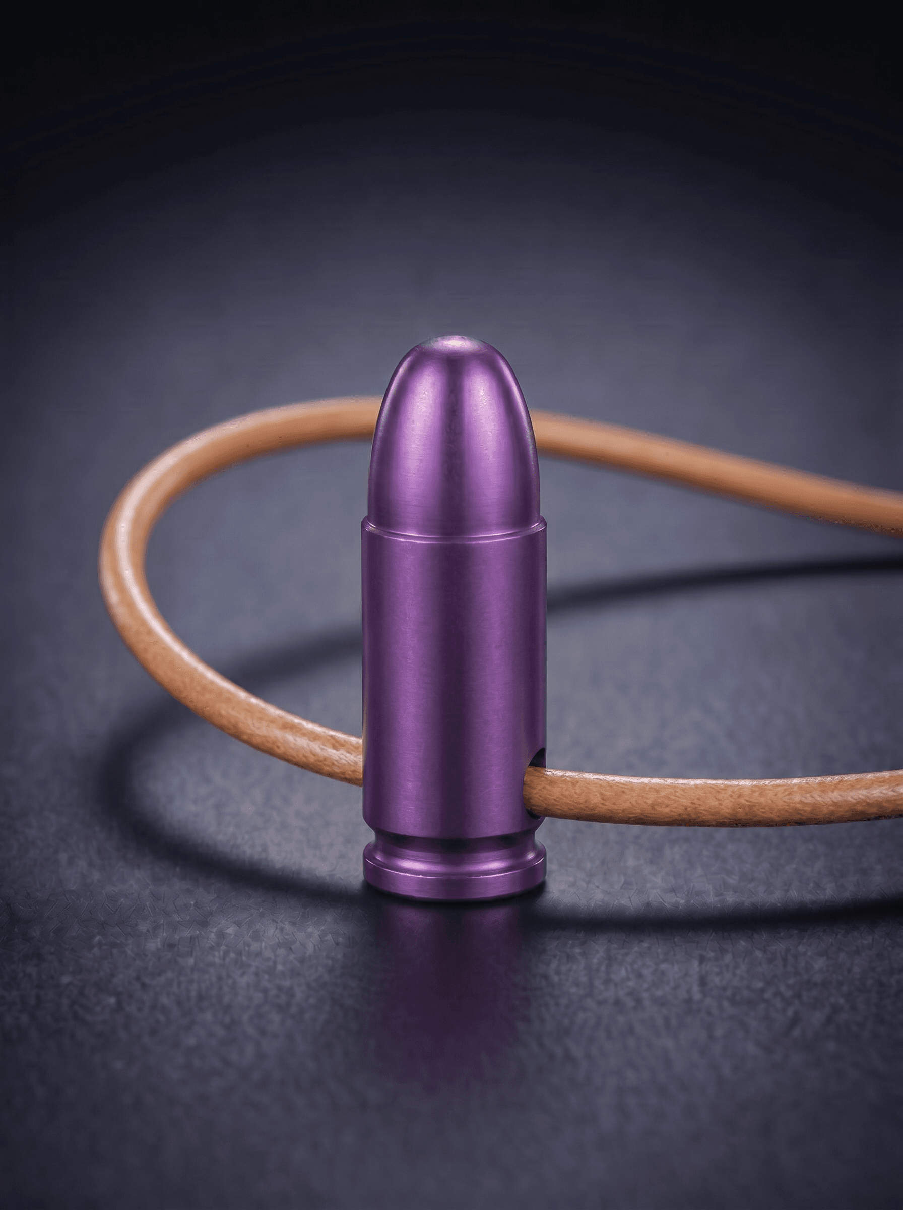 Pistol Cartridge in magenta on original leather cord — view 1 — Wear Metal